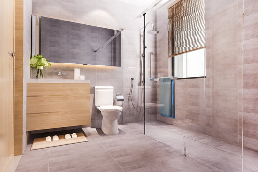 Modern bathroom featuring a toilet bowl, a wooden bathroom cabinet with a basin, and a glass shower set representing high-quality sanitary ware and bathroom accessories.