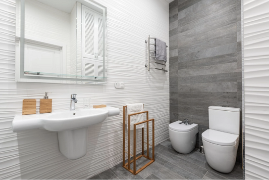 Modern bathroom with textured wall tiles, grey feature wall, wall-mounted basin, and toilet.
