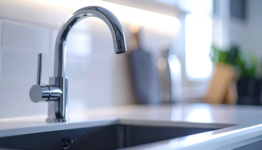 Modern mixer sink tap installed on a kitchen countertop beside a sink.